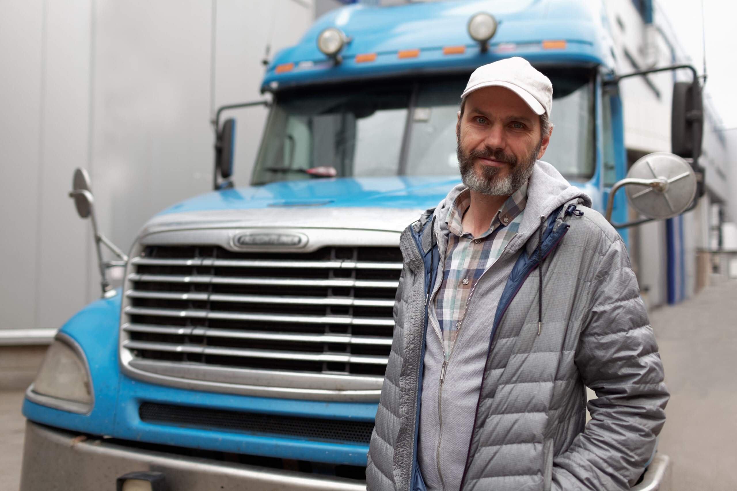 Mature bearded man against retro styled truck